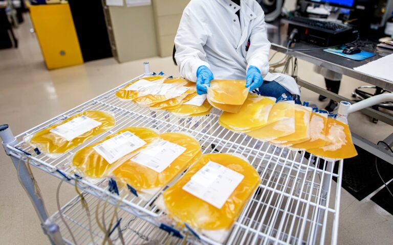 A,Wide,Shot,Of,A,Lab,Worker,Handling,Bags,Of
