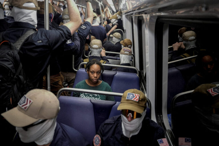A picture and its story: Patriot Front members and a solitary woman travel on a DC train