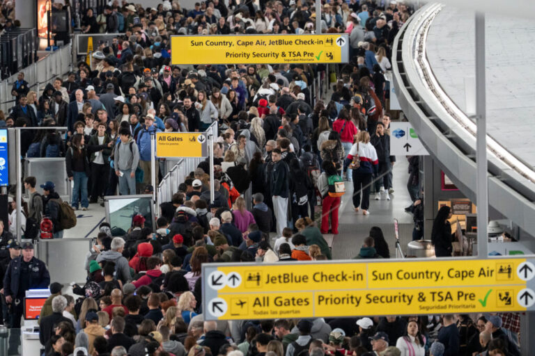 People wait in a TSA line at John F. Kennedy International Airport