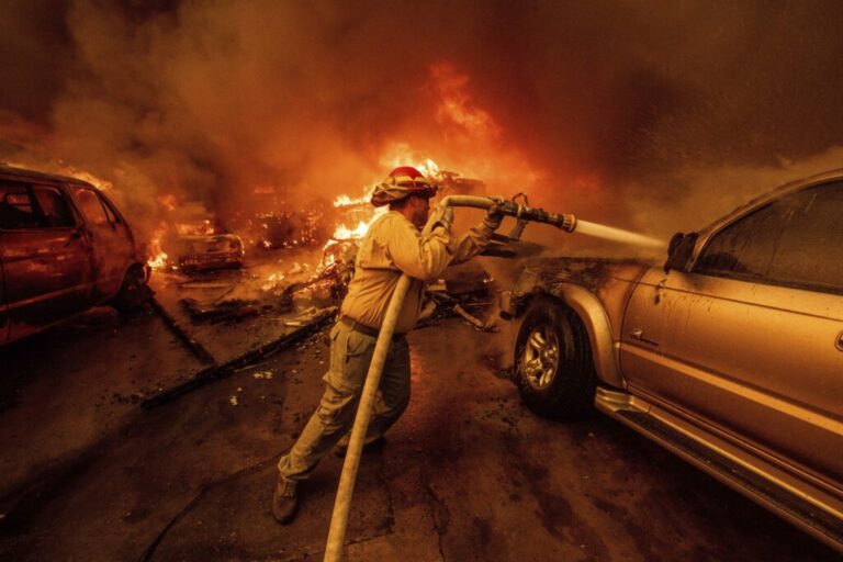 A firefighter battles the Eaton Fire.