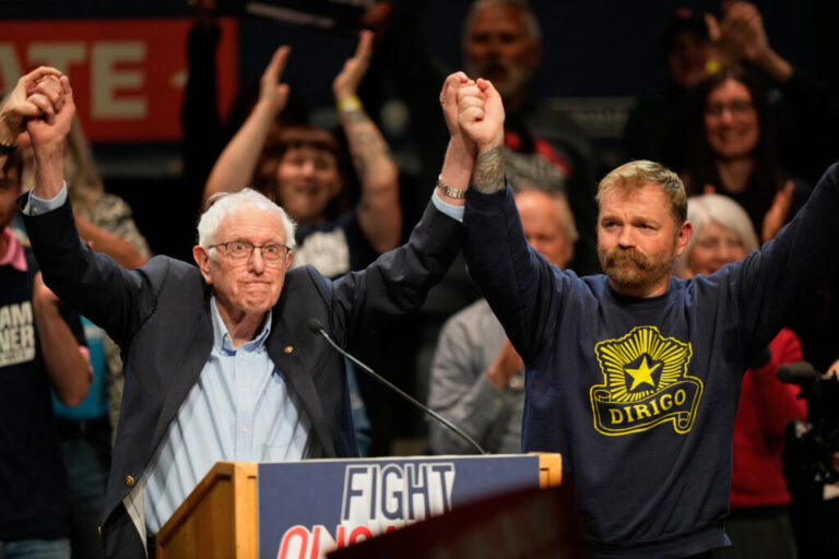 Graham Platner, Democratic candidate for U.S. Senate, and Sen. Bernie Sanders, I-Vt., left, join hands.