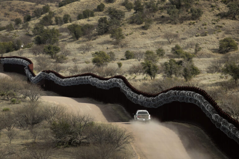 Customs and Border Control agent patrols on the U.S. border wall in Nogales, AZ.