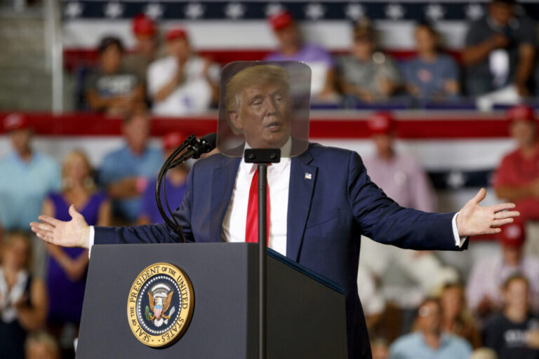 President Donald Trump is seen though a teleprompter