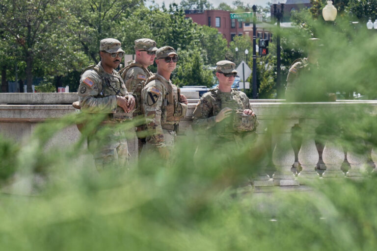 National Guard soldiers keep watch as people walk at Union Station.