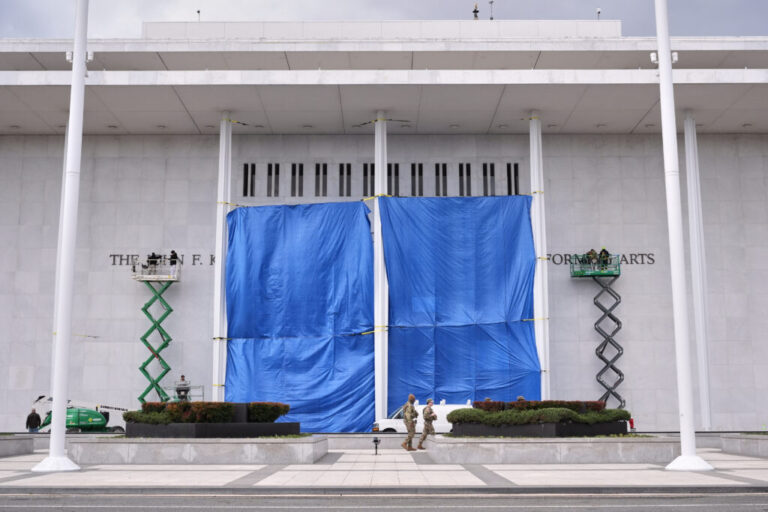 Workers install Donald J. Trump's name above the current signage on the Kennedy Center.